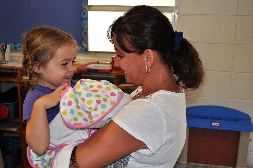 Avery Carver, 4, jumped into the arms of her former teacher, Natlaiya Fesko, Monday, Aug. 20, at St. Boniface Preschool.