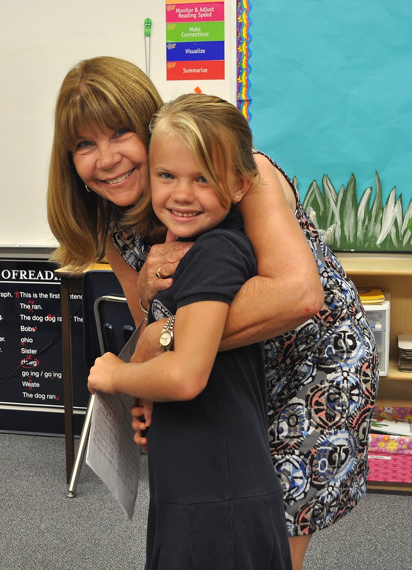 Mrs. Frances Williams gives her student, Shelby Liashek, 6, a big hug, Wednesday, Aug. 22.