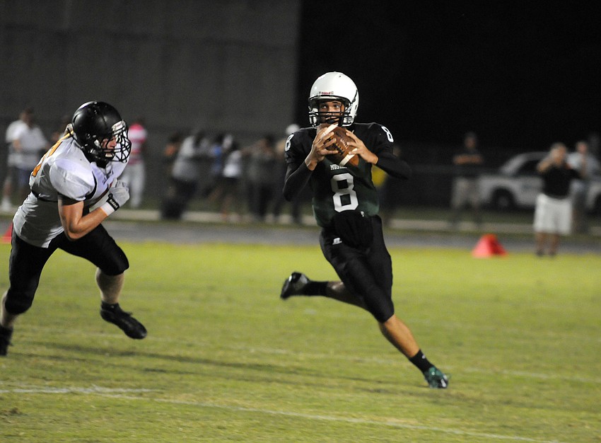 Sophomore quarterback Chad Rex rolls out for a pass in the first half.