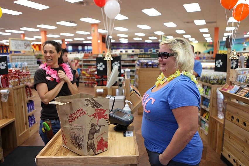 Amy Armstrong checks out Erin Smith, the first customer on opening day Friday, Sept. 7.