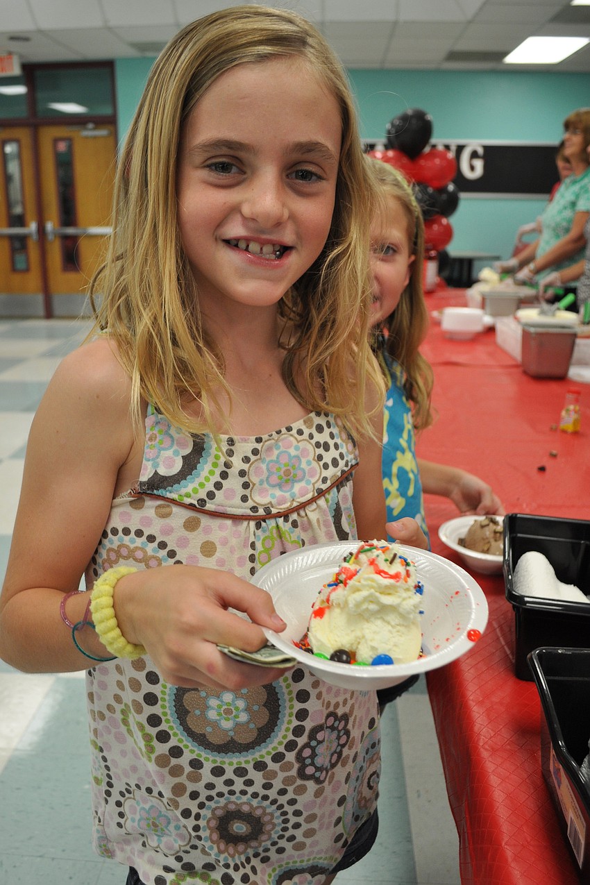 Lizzy Dawson, 9, put sprinkles, strawberry syrup and M&Mâ€™s on her vanilla ice cream.