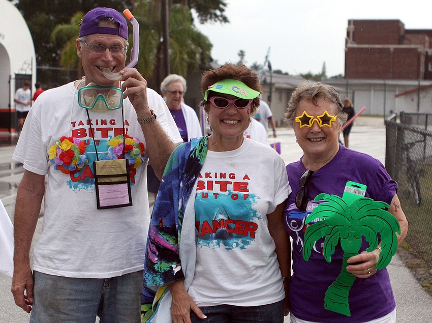 Cary and Marie Zolot walk with their teammate Doris Deccelle, Saturday, April 28.