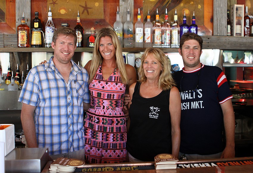Tommy, Megan, Linda and Brett Wallin pose behind the bar of the Chickee Bar at Waltâ€™s Fish Market, Sunday, May 27.
