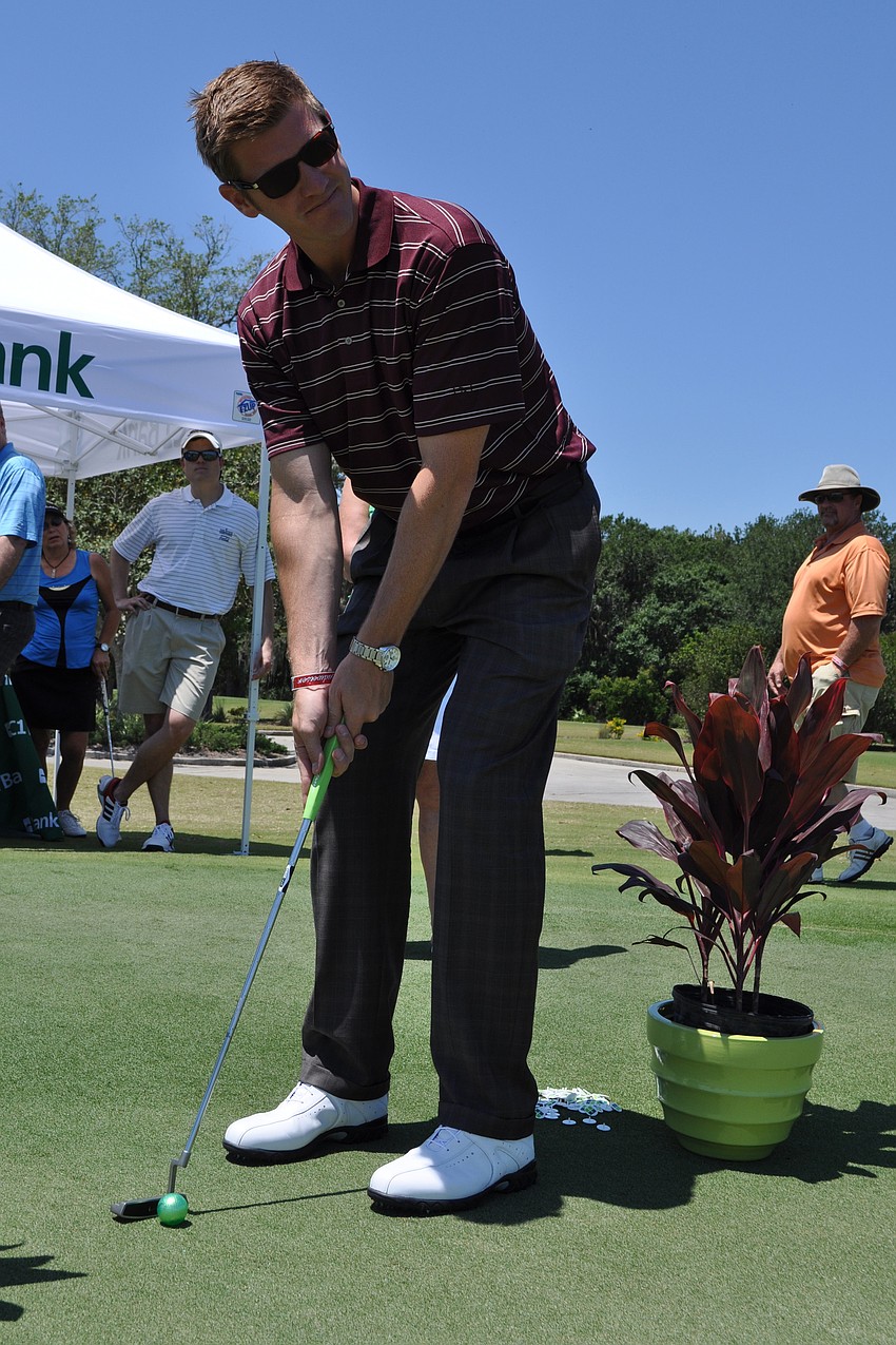 Jonathan Schneider tried his aim in a putting contest.