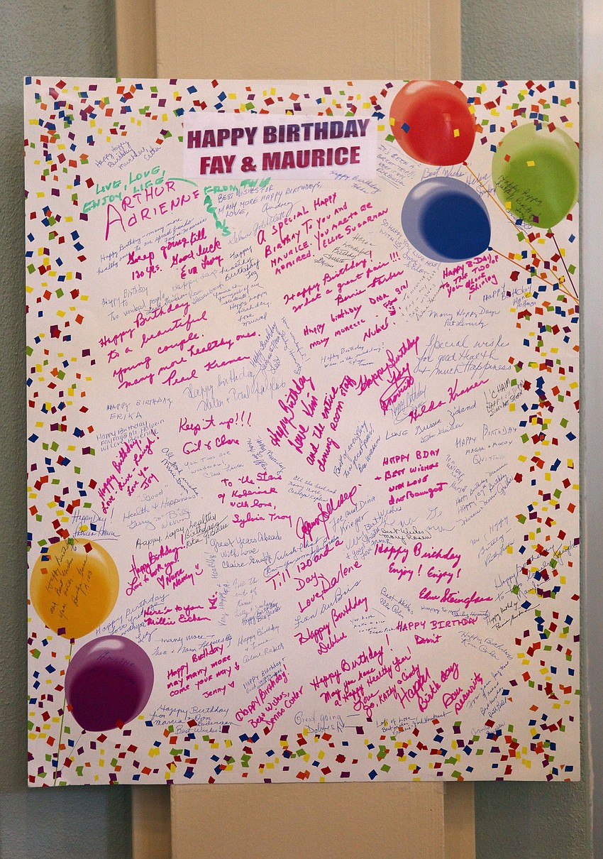 Many people signed a large birthday card for Fay Watkins and Maurice Halpern.