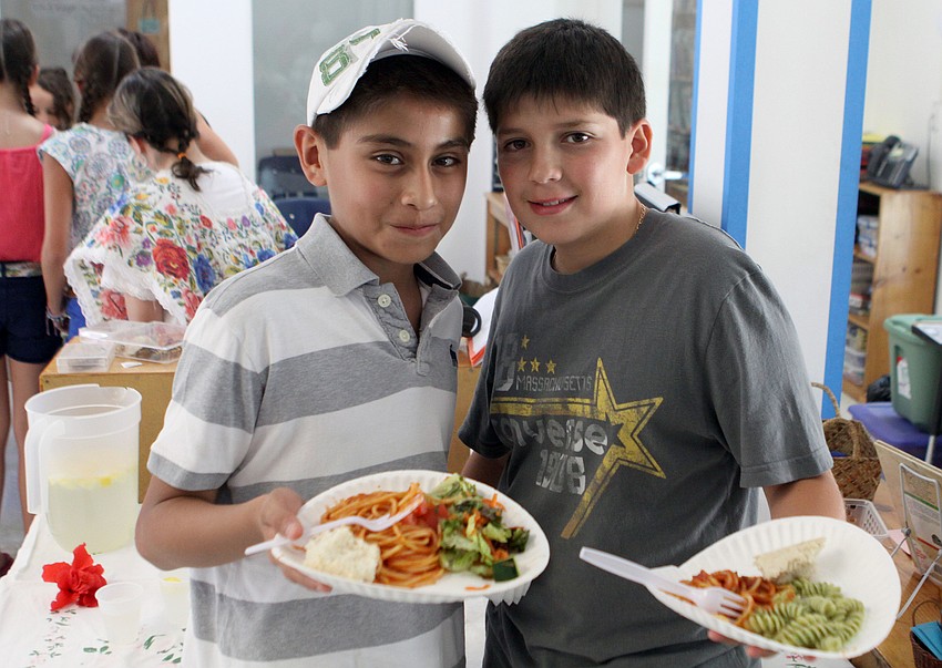 Fernando Leon, 12, and Rodrigo Irianda, 13, enjoy some lunch, Thursday, April 26, at the NewGate School.