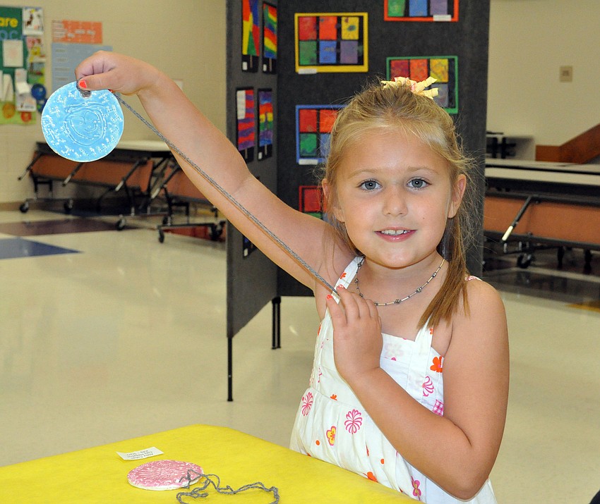 Kindergartener Alexis Schilling enjoyed painting her medallion.