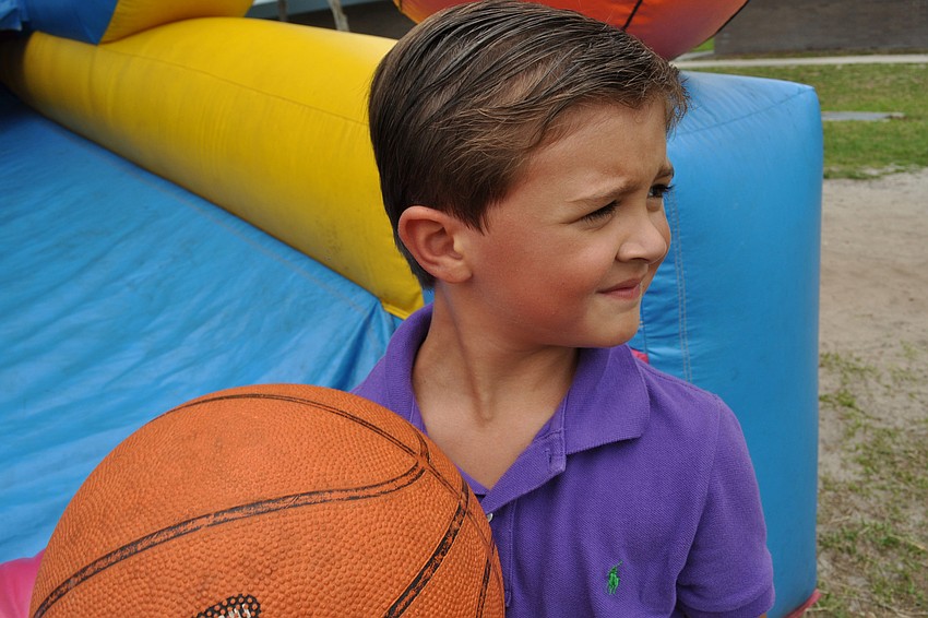 Mason McRae, 5, tried his aim at the basketball shoot game.