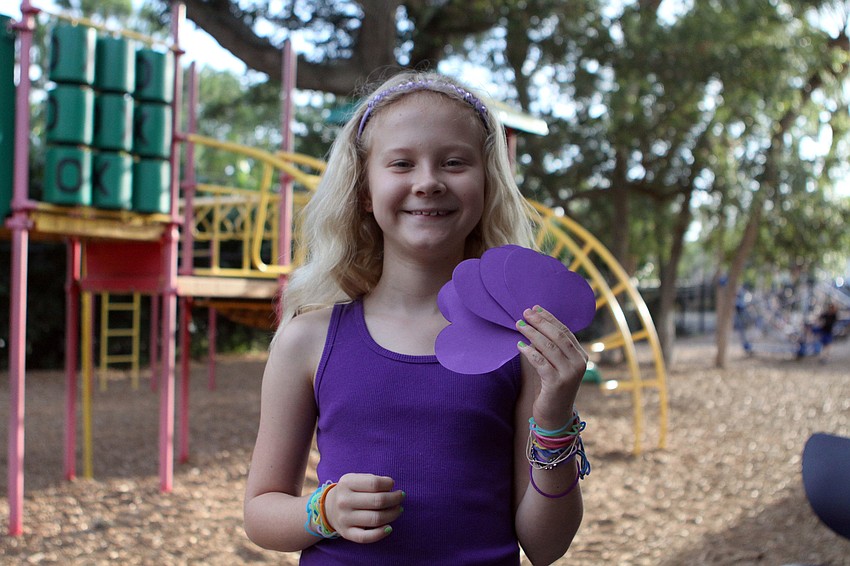 Esme Cullen, 8, shows off something she made while spending the evening at Out-of-Door Academy, Saturday, May 5.