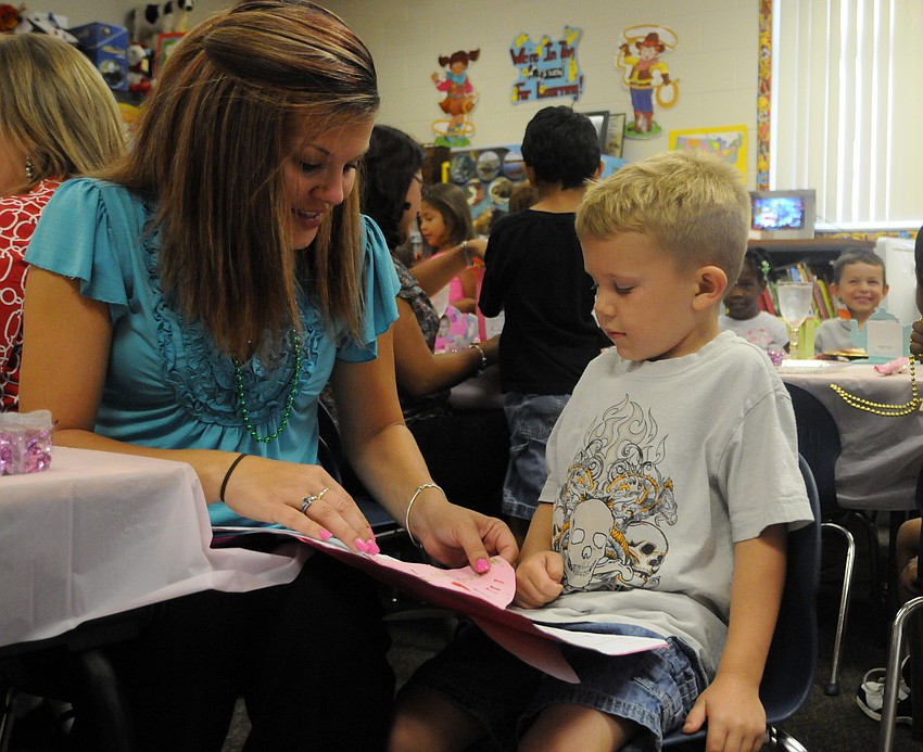 Heather Parrish reads a book that her six-year-old son Wyatt made her for Motherâ€™s Day.