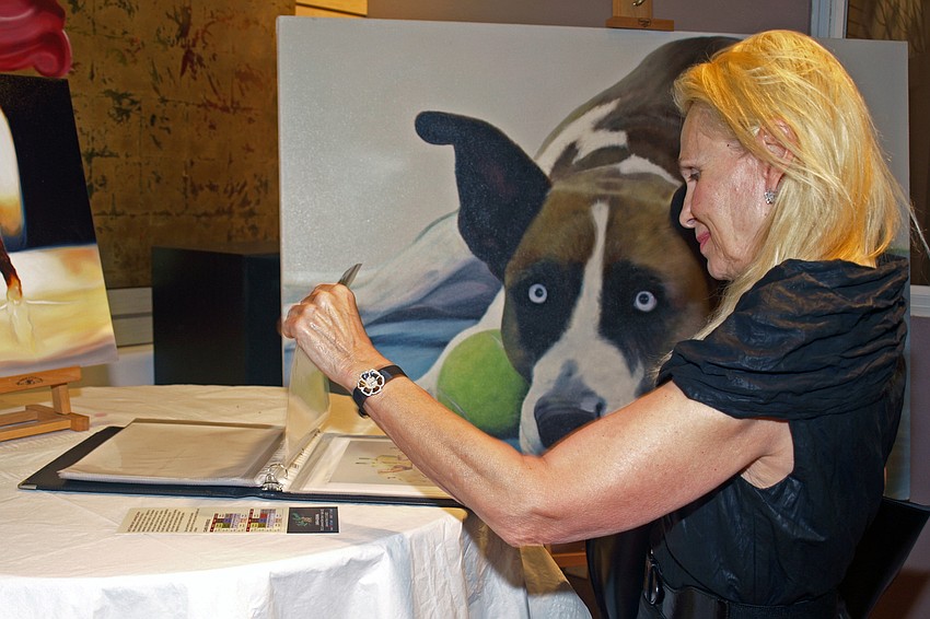 Guest Owanza di Mdina looked at the works of artist and Let's Create Art owner, Clark Prosperi.