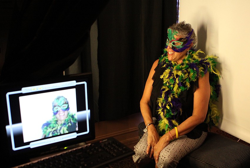 Adrienne Combs poses in the photo booth Sunday, June 3, at Michaelâ€™s On East.