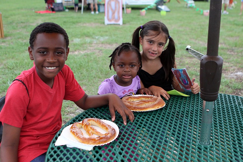 Myles Woodard, 9, Kyla Woodard, 2, and Hannah Bartholomew, 6, get ready to enjoy their pretzels.