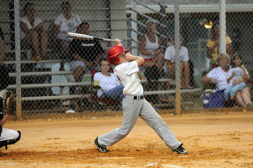 Eleven-year-old Brock Nelson swings for the fence during Carroll and Suttonâ€™s quarterfinal game June 8.