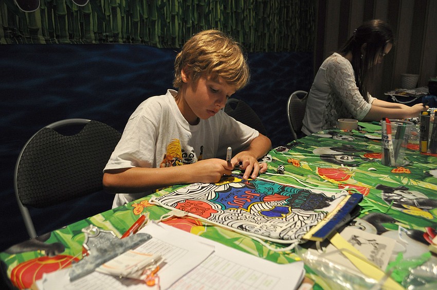 Beck Linehan works on a backpack that will be donated to underprivileged children abroad.