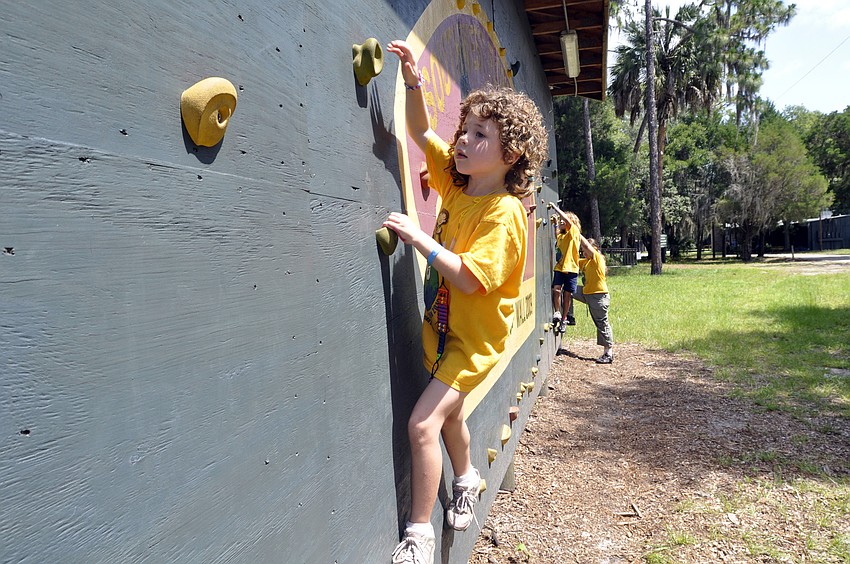 Six-year-old Amberlie Hargett made several trips around the rock wall cabin.
