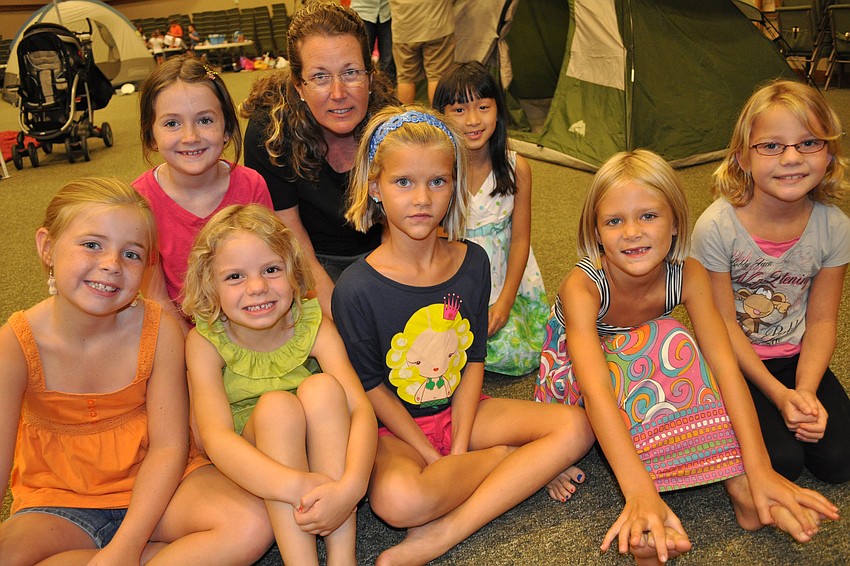 Volunteer Kelly McCann is pictured with the girls on her team, the Blue Baboons.