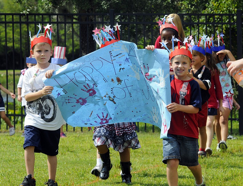 Justin Mitchell and Adam Cohen led the parade along with the rest of the schoolâ€™s summer camp participants.
