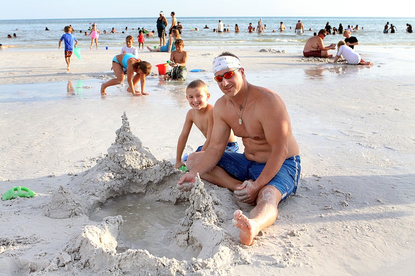 Keelan Peck, 7, and his dad, Mike, built a sandcastle to pass the time before the fireworks, Wednesday, July 4, on Siesta Key Public Beach.