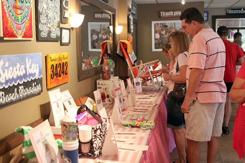 There were many items up for auction at the Drink Pink event, Saturday, July 14, at the Village CafÃ©. Tickets to a Buccaneers game and a two-night stay at the Serata Beach Resort were two of the most sought after items.