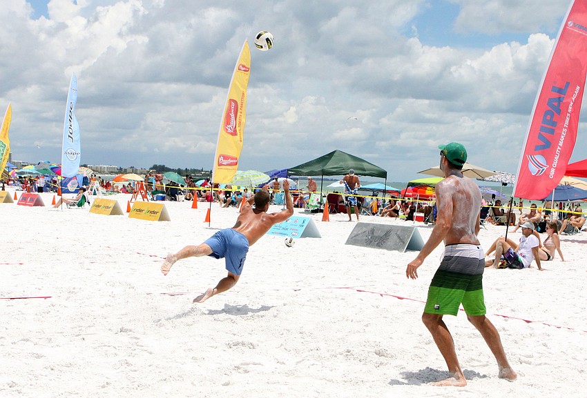 Kent Ammons dives to save the ball from going out of bounds while his teammate, Diogo Sousa prepares to help.