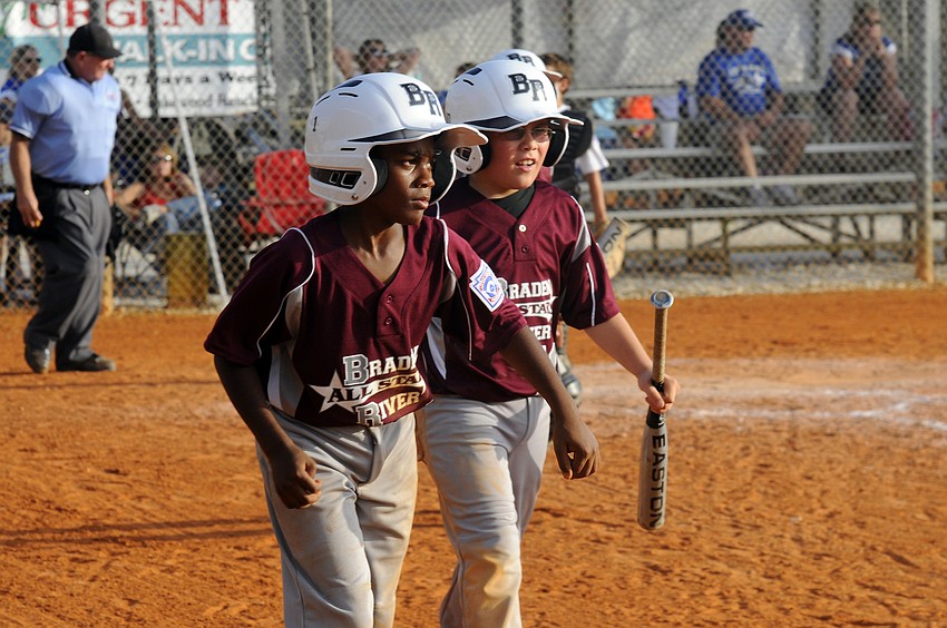 Braden River Little League 9-10 Al-Star teammates Maleek Huggins and Dylan McCranie celebrate after scoring early in their game against Buffalo Creek White.