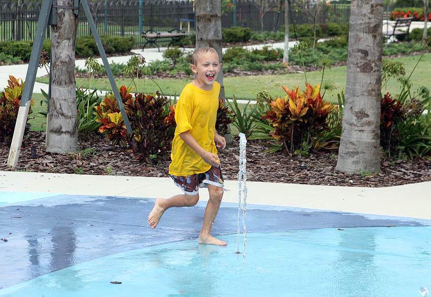 Jonah Bean, 7, runs around Splash Park at Central Park.