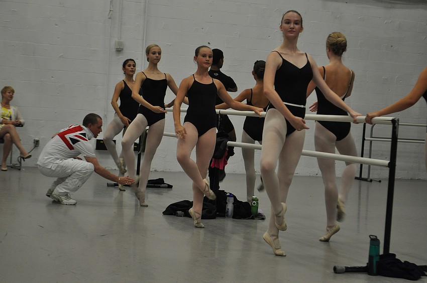 Sarasota Ballet Director Iain Webb adjusts one of his studentâ€™s feet