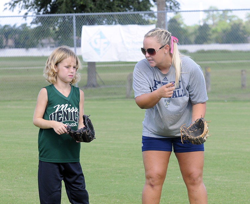 Eight-year-old Breanna Neeley receives infield instruction from former Lakewood Ranch High and Florida International University third baseman Kelsey Grabiak.