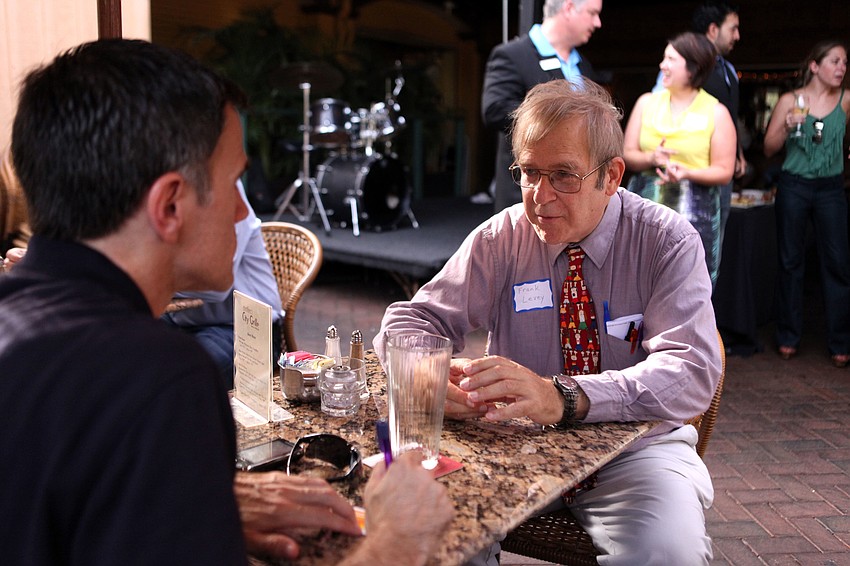 Frank Levey tries to pitch himself in a minute-and-a-half to Mark Black, Tuesday, July 31, during AAF Suncoastâ€™s Speed Networking event at Mattisonâ€™s.