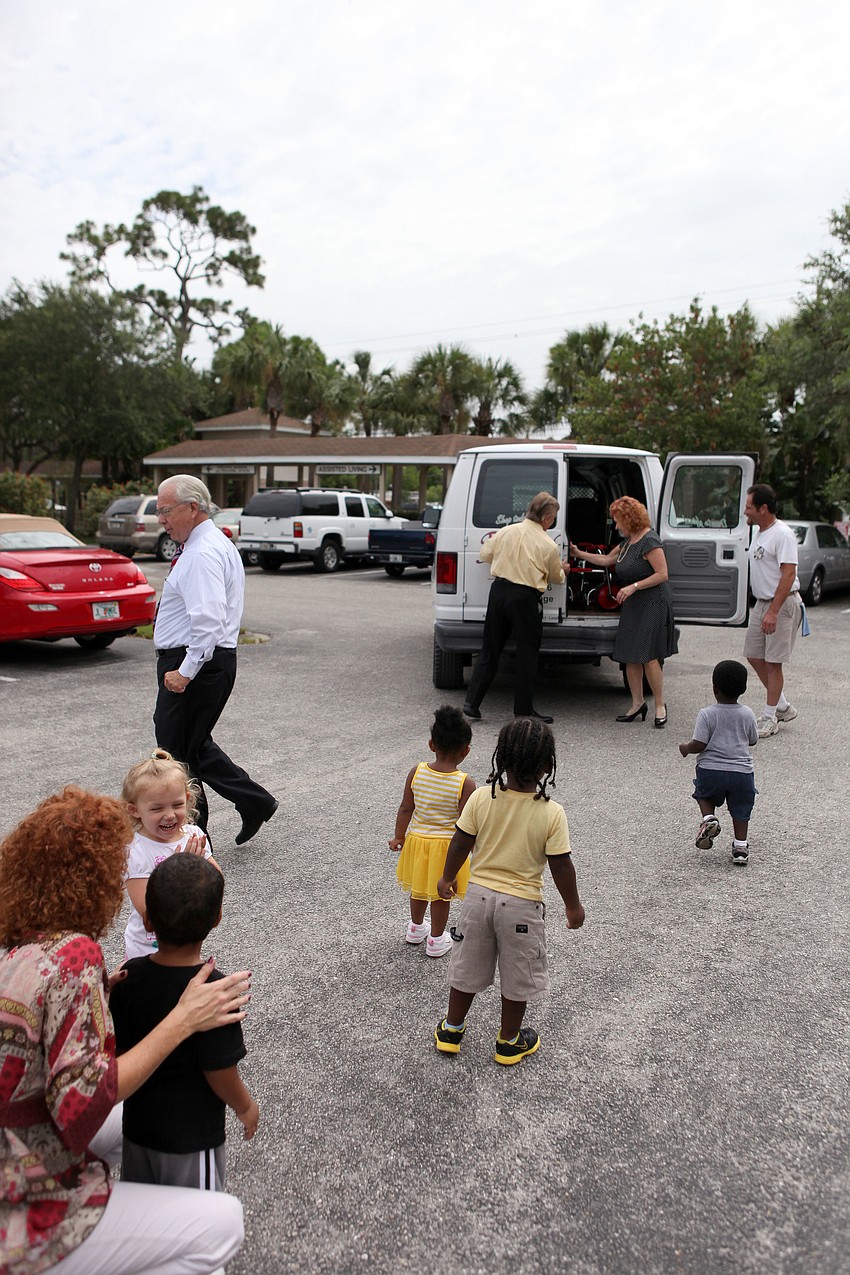 The toddlers make their way towards the van filled with tricycles donated by the Rotary Club of Sarasota Bay.