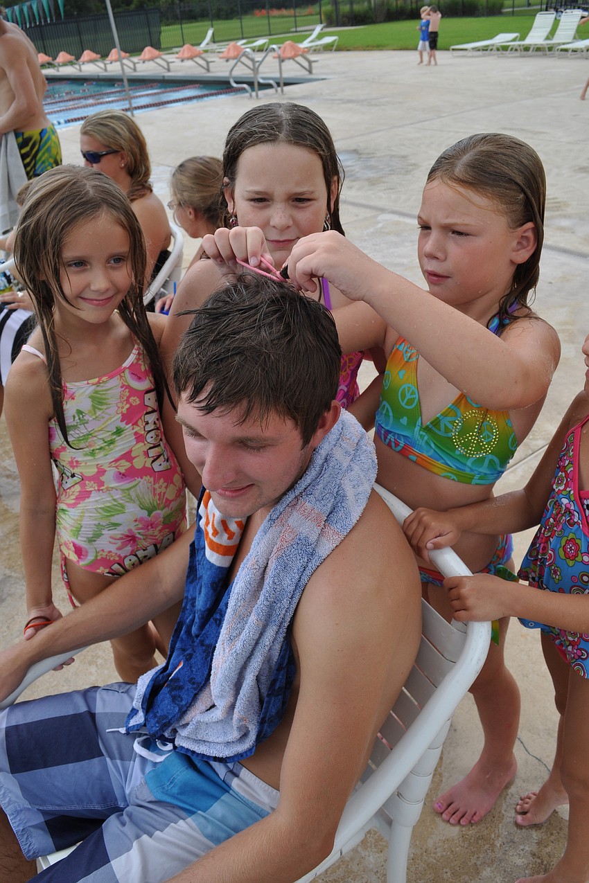 Camp counselor Joel Ferguson stayed still as Faith Miller, Josie French and Carys Crombie attempted to style his wet hair.