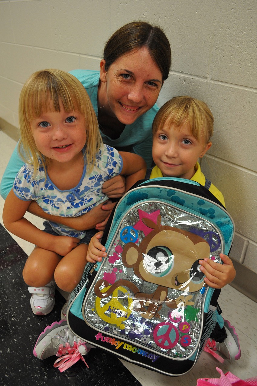 Five-year-old Elizabeth Sabine, right, spent time with her sister, Emma, and mom, Jessica, before heading into class.