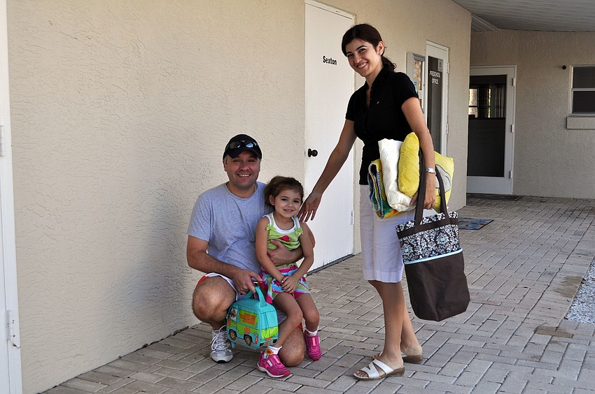 Helene Giraud poses with her dad and mom, Claude and Nidale Giraud, prior to heading into her classroom, Monday, Aug. 20.