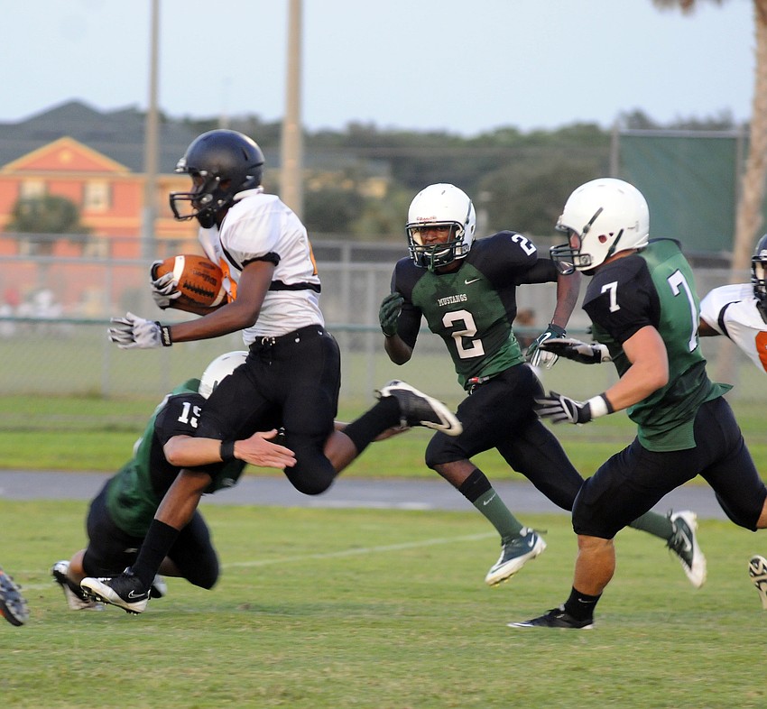 Lakewood Ranch senior defensive back Nick Isemann tries to keep Sarasota running back Garrett Miller from breaking into the open field.