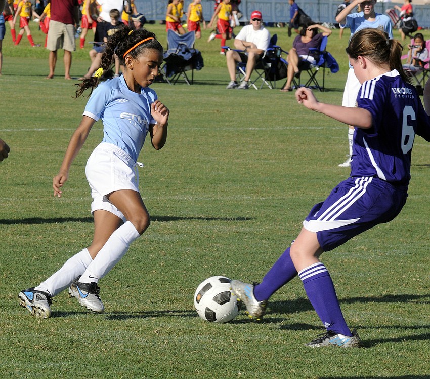 Eleven-year-old Angelina Kapiniaris, left, looks to regain possession.