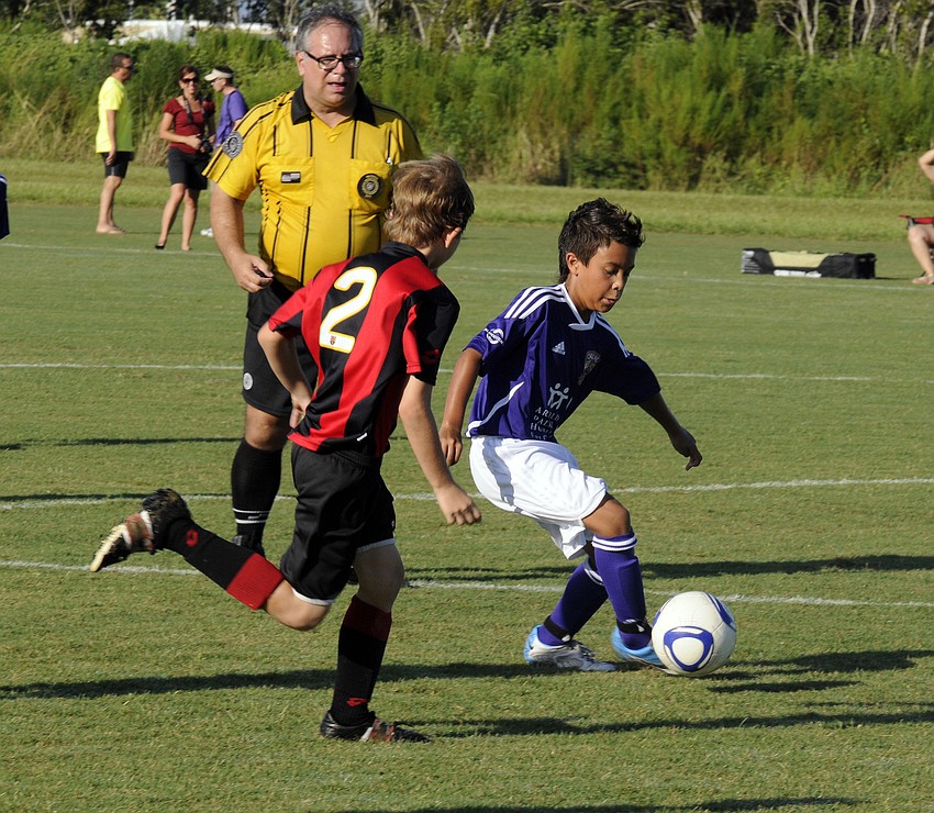 Orlando City Soccer center midfielder Memphis Parker brings the ball up the field.