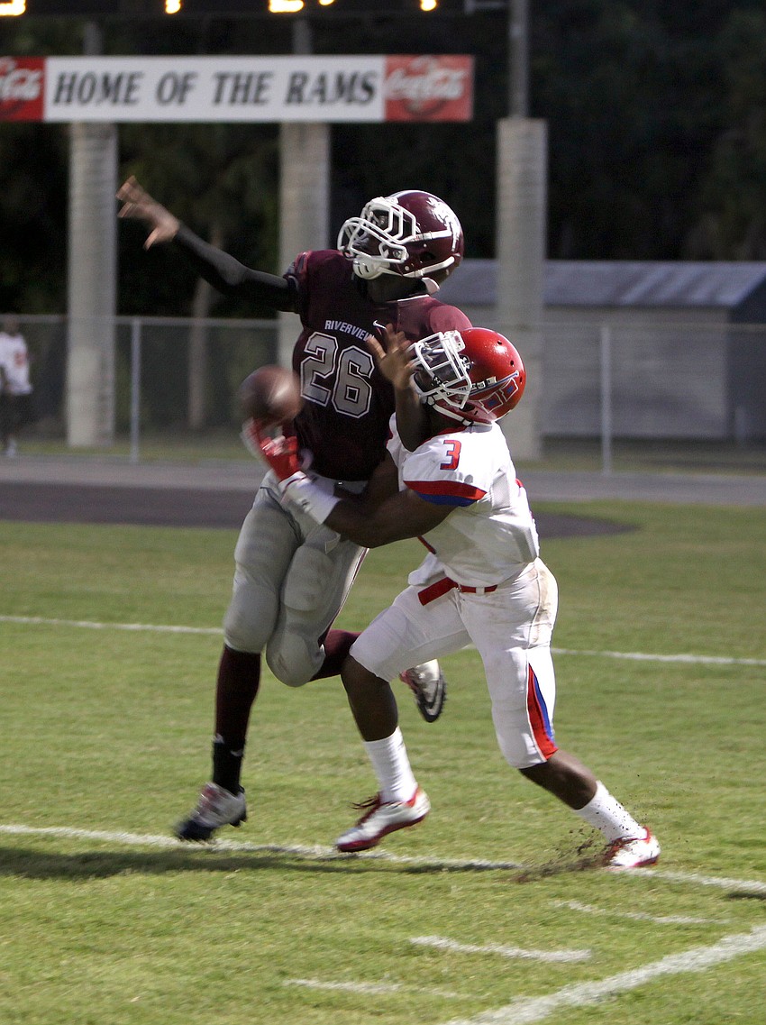 Lorenzo Dennie, No. 26, and Ja Juan Pollock, No. 3, both attempt to catch the ball during the game Friday evening at the Ram Bowl.