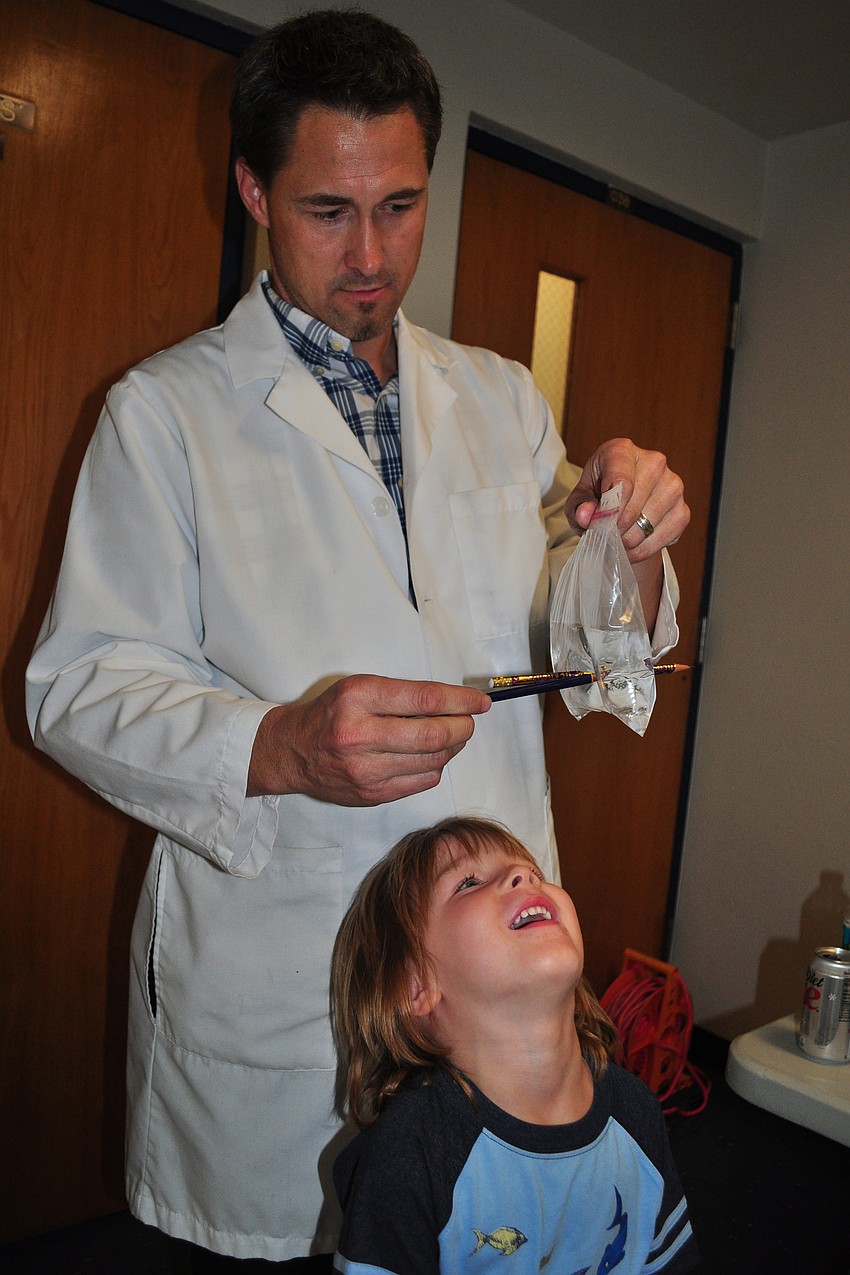 Teacher Stephen Spisak showed attendees how polymers worked. His son, Ryder, assisted with the demonstration.