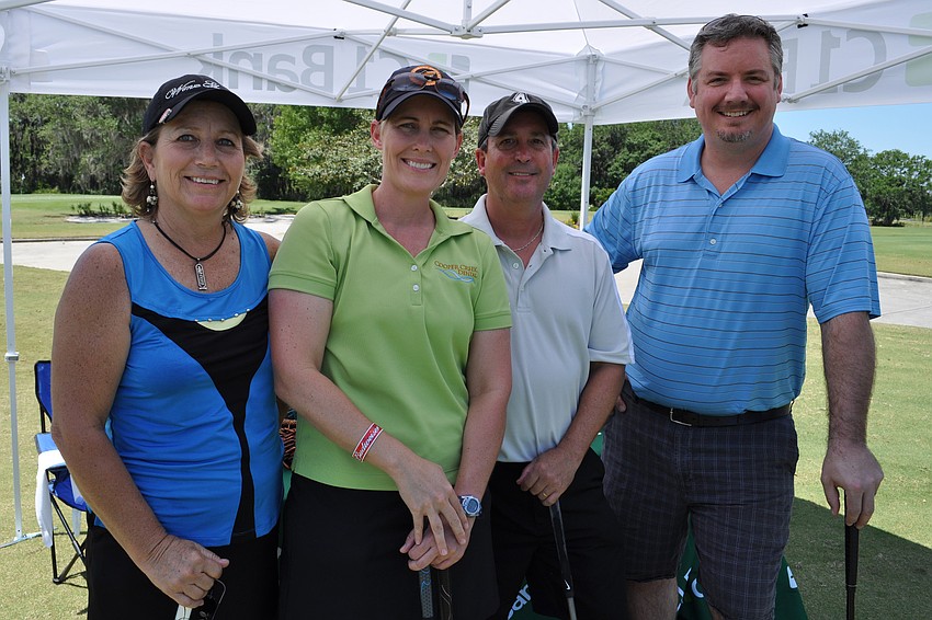 Dee Donegan, Dr. ShellyMcAvoy, Marc Simms and Matthew Anderson were eager to test their aim at a putting challenge.