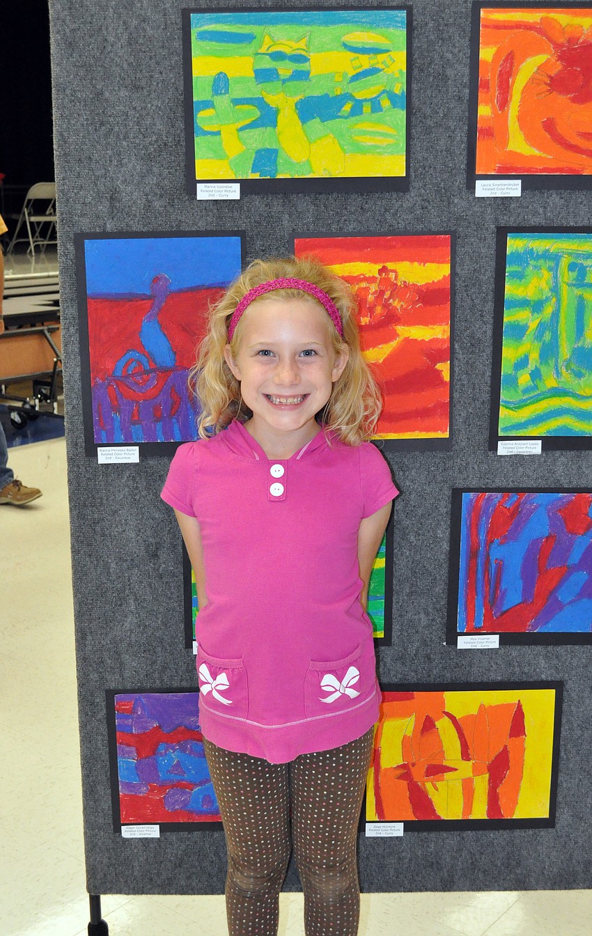 Seven-year-old Marina Valentine drew a cat using colored pastels.