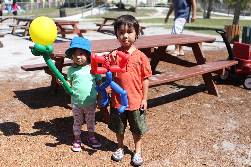 Moorea, 2, and Ryder, 4, LaBar show off their balloon creations.