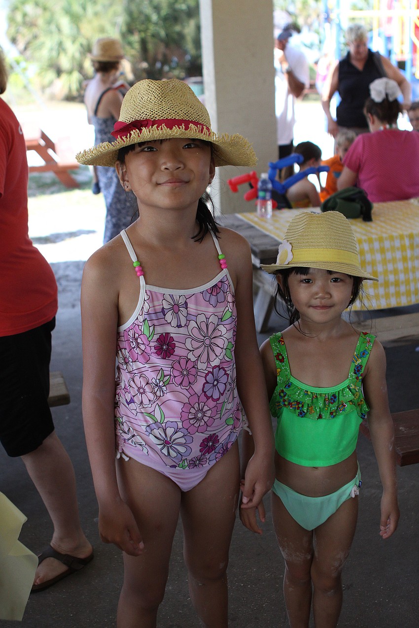 Licia, 8, and Felicity, 4, Liu both wore stylish hats to the St. Boniface Preschool Picnic on Saturday.