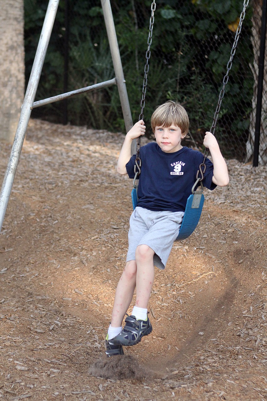 Landon Fiumfreddo, 5 Â½, swings on the swing set, Saturday, May 5, at ODA.