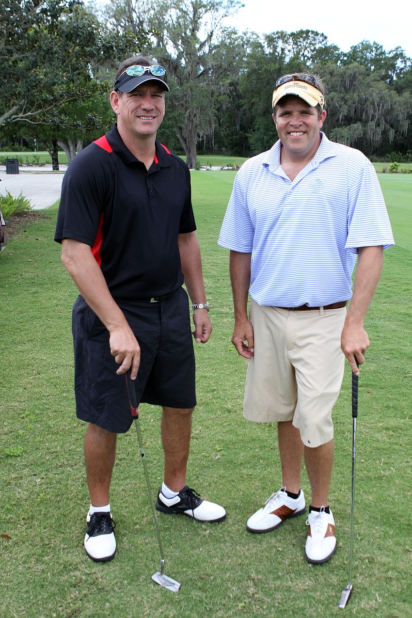Ed Doughty and Tom Kochis eat their brown bag lunch in their cart.