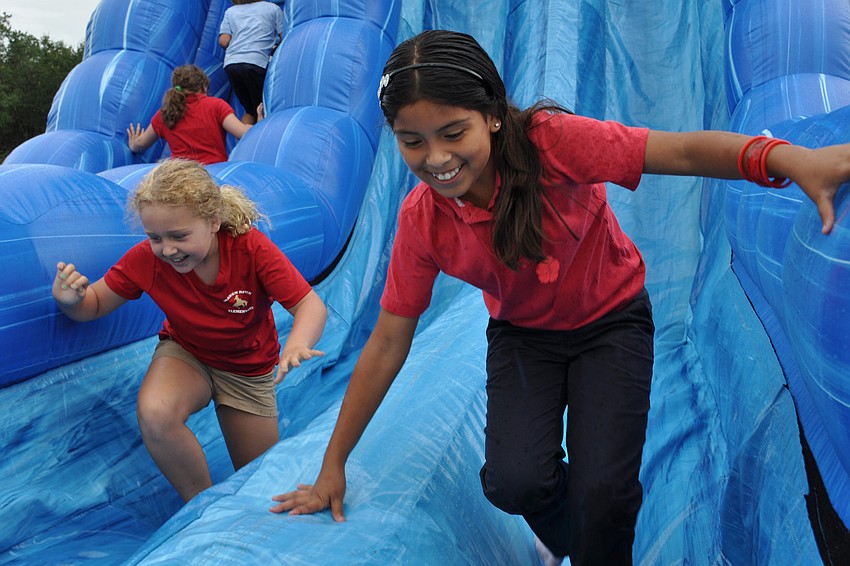 Lusero Acosta, front, and Lizzy Ebury, behind, went on the slide as many times as they could.