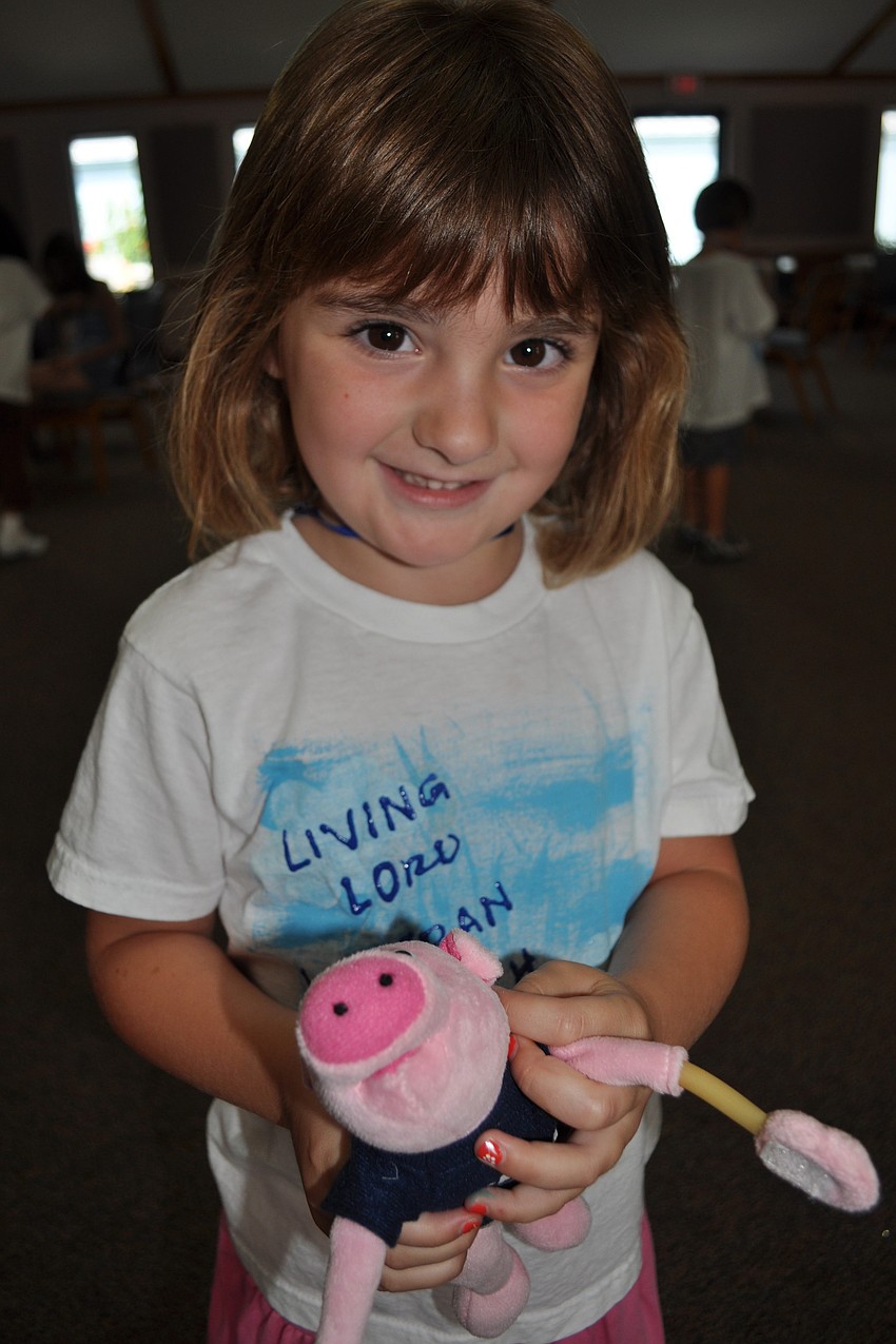 Ingrid Pope, 4, showed of Orville, the pig.