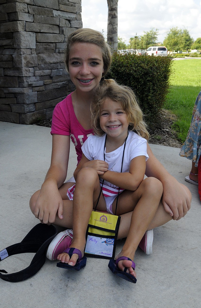 Four-year-old Molly Abraham and Braden River Middle School seventh-grade volunteer Tali Leckie.