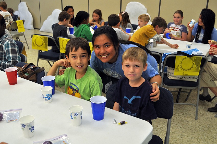 Ching Ching Caballero poses with students Nico Telles and Alix Warren.