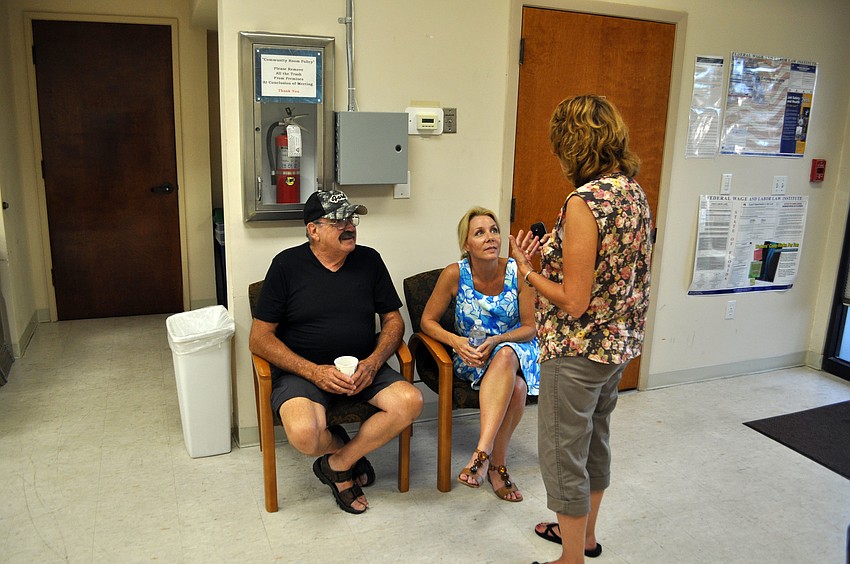 Church members converse at the open house.